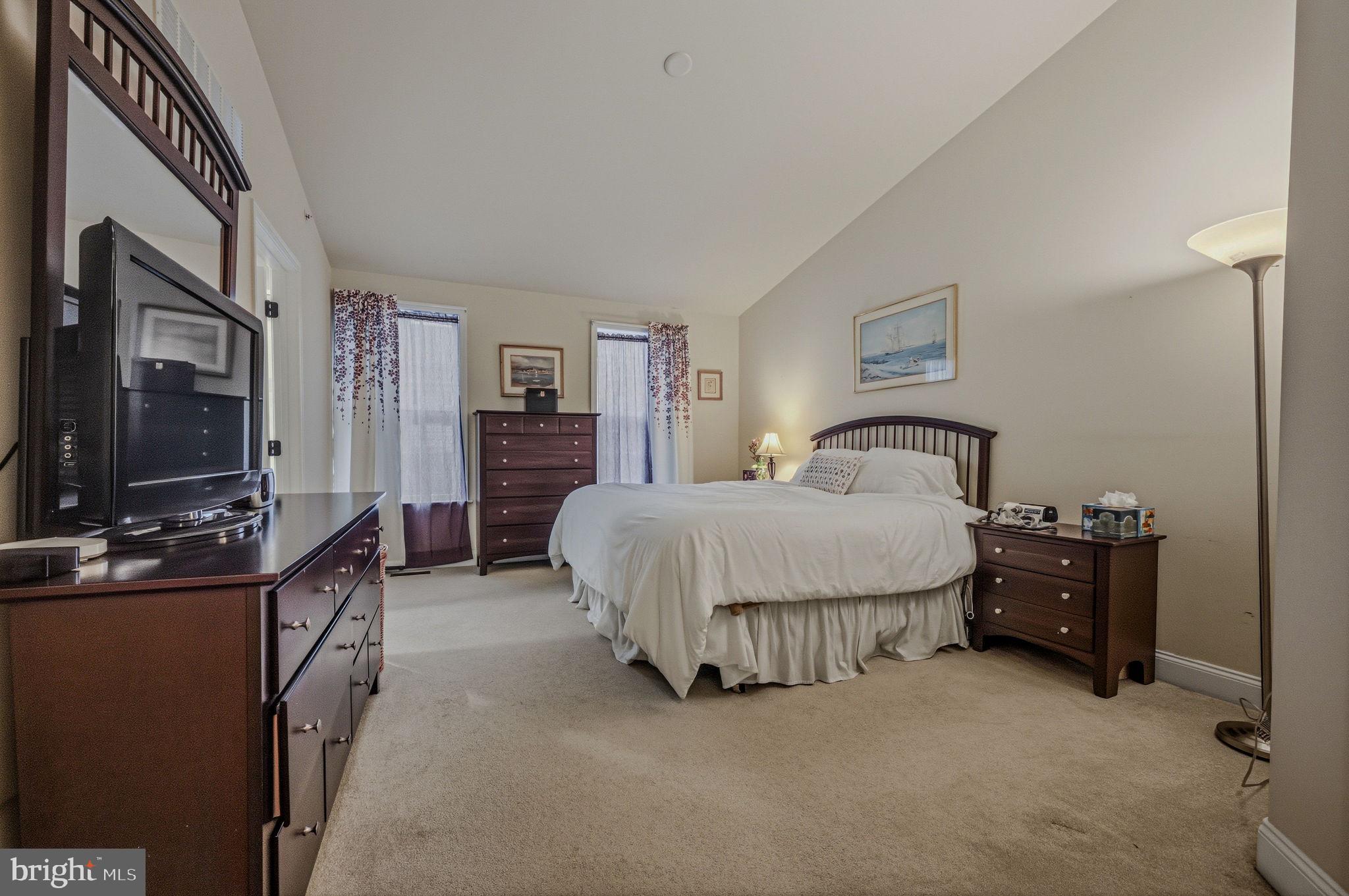 208 Jackdaw Alley, Unit 208 Springfield, PA 19064 - Photo 27 of 43 a spacious bedroom with a bed and dresser