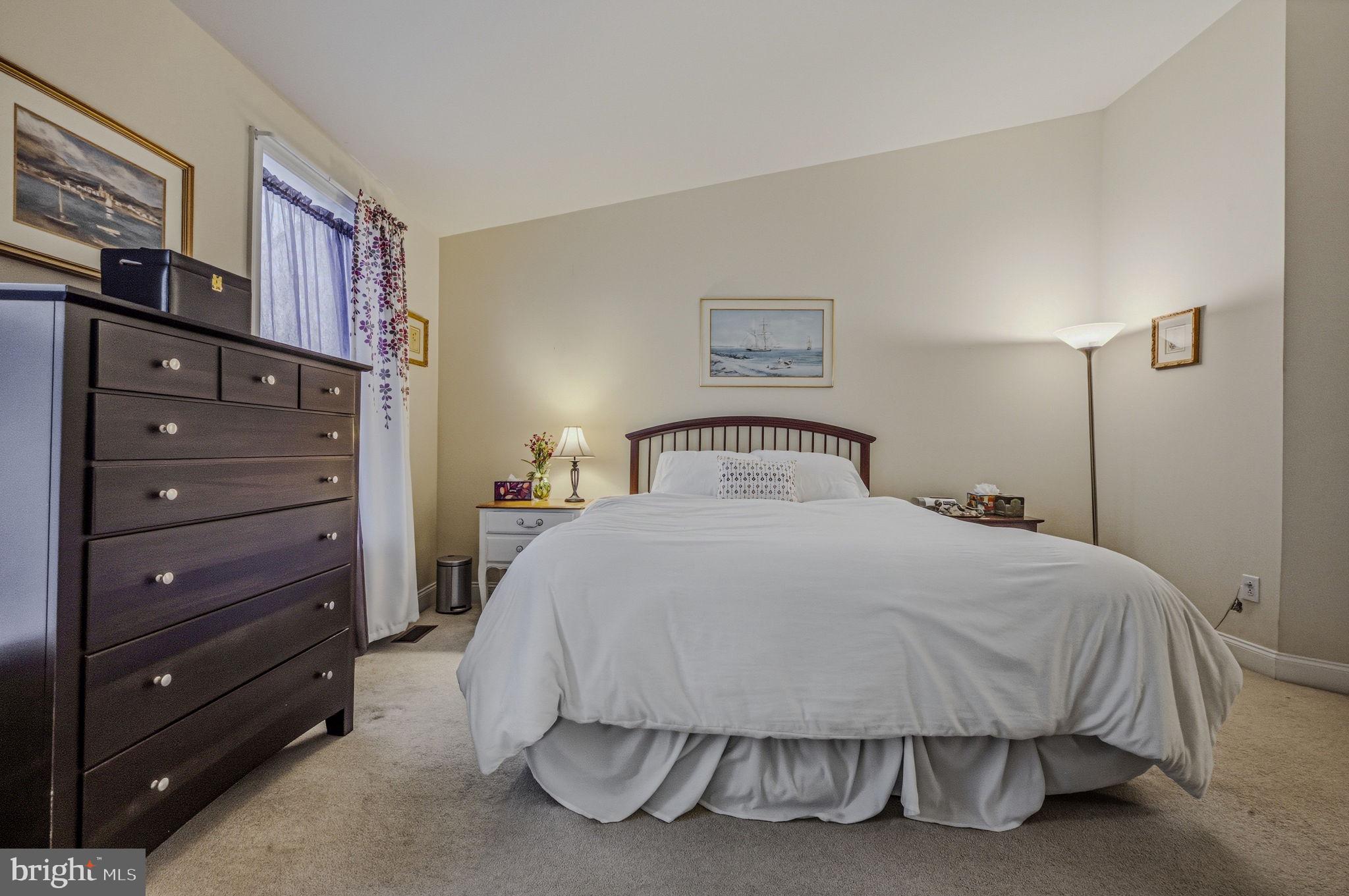 208 Jackdaw Alley, Unit 208 Springfield, PA 19064 - Photo 28 of 43 a bedroom with a bed and a painting on the wall