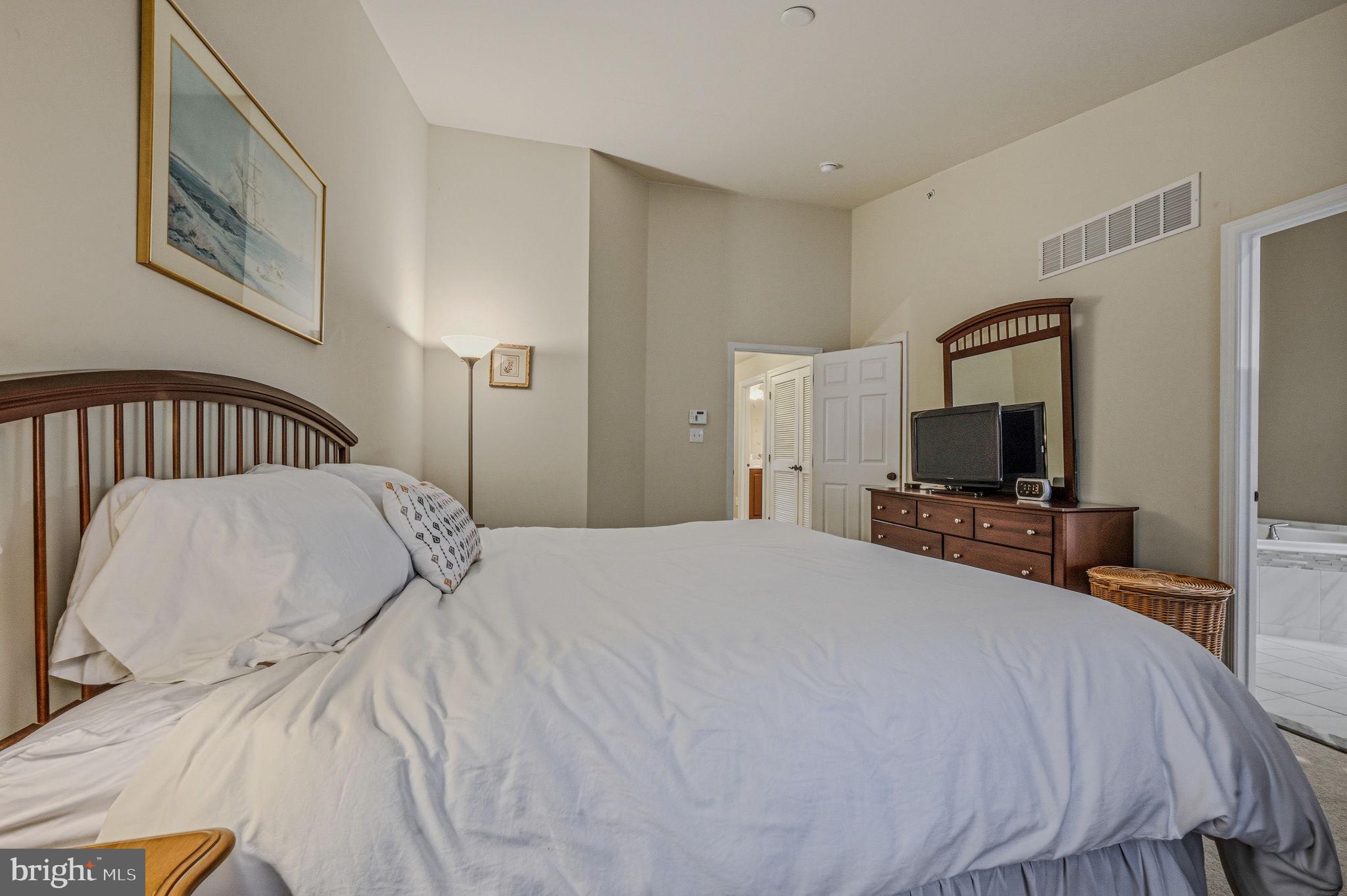 208 Jackdaw Alley, Unit 208 Springfield, PA 19064 - Photo 29 of 43 a bedroom with a bed and a flat screen tv