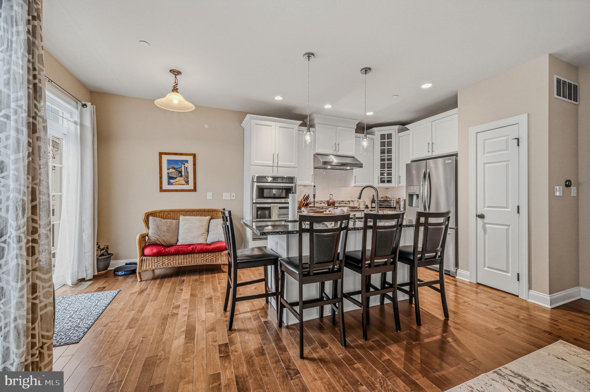 208 Jackdaw Alley, Unit 208 Springfield, PA 19064 - Photo 5 of 41 a living room with stainless steel appliances kitchen island furniture and wooden floor