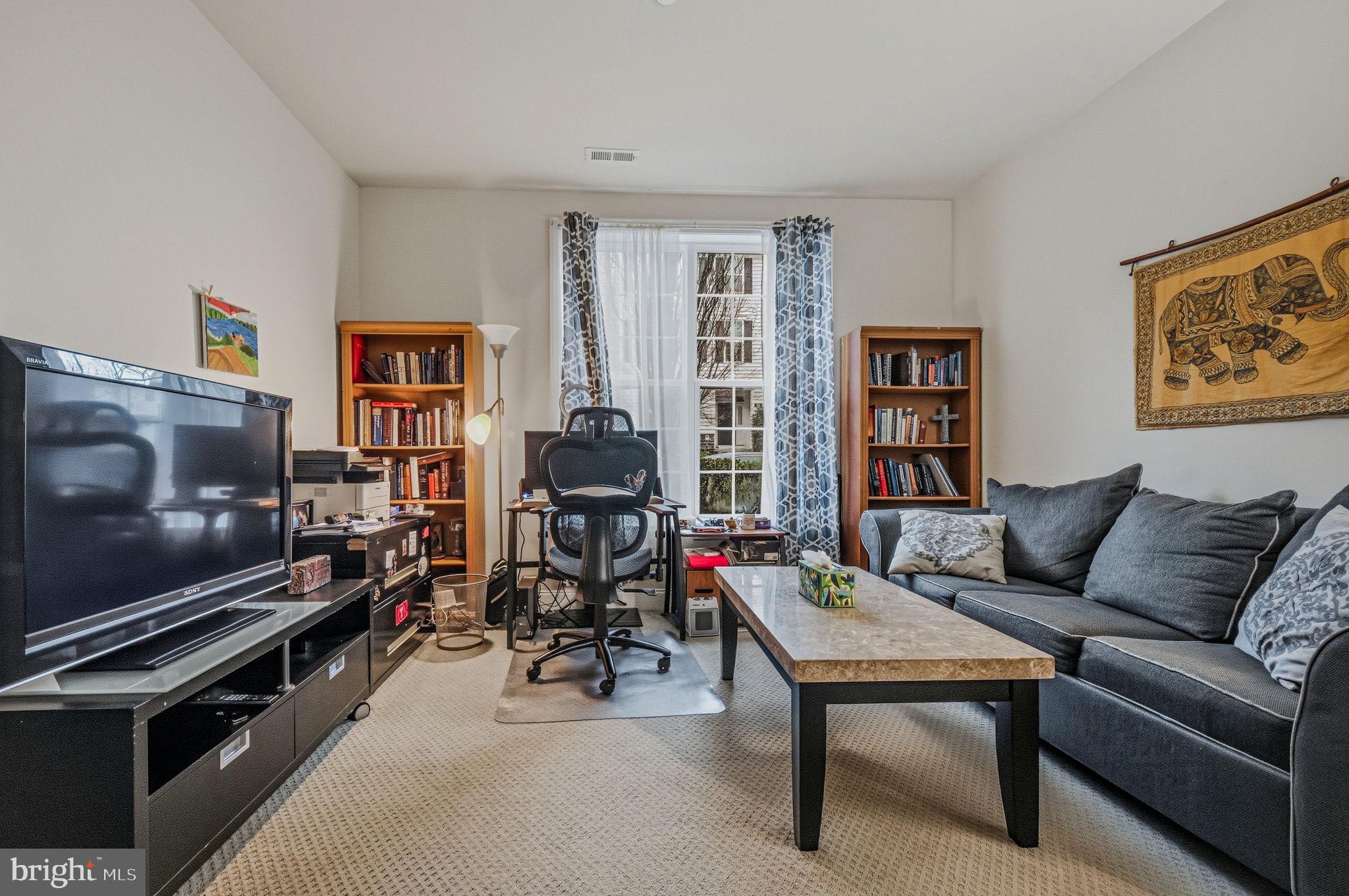 208 Jackdaw Alley, Unit 208 Springfield, PA 19064 - Photo 6 of 43 a living room with furniture and a flat screen tv
