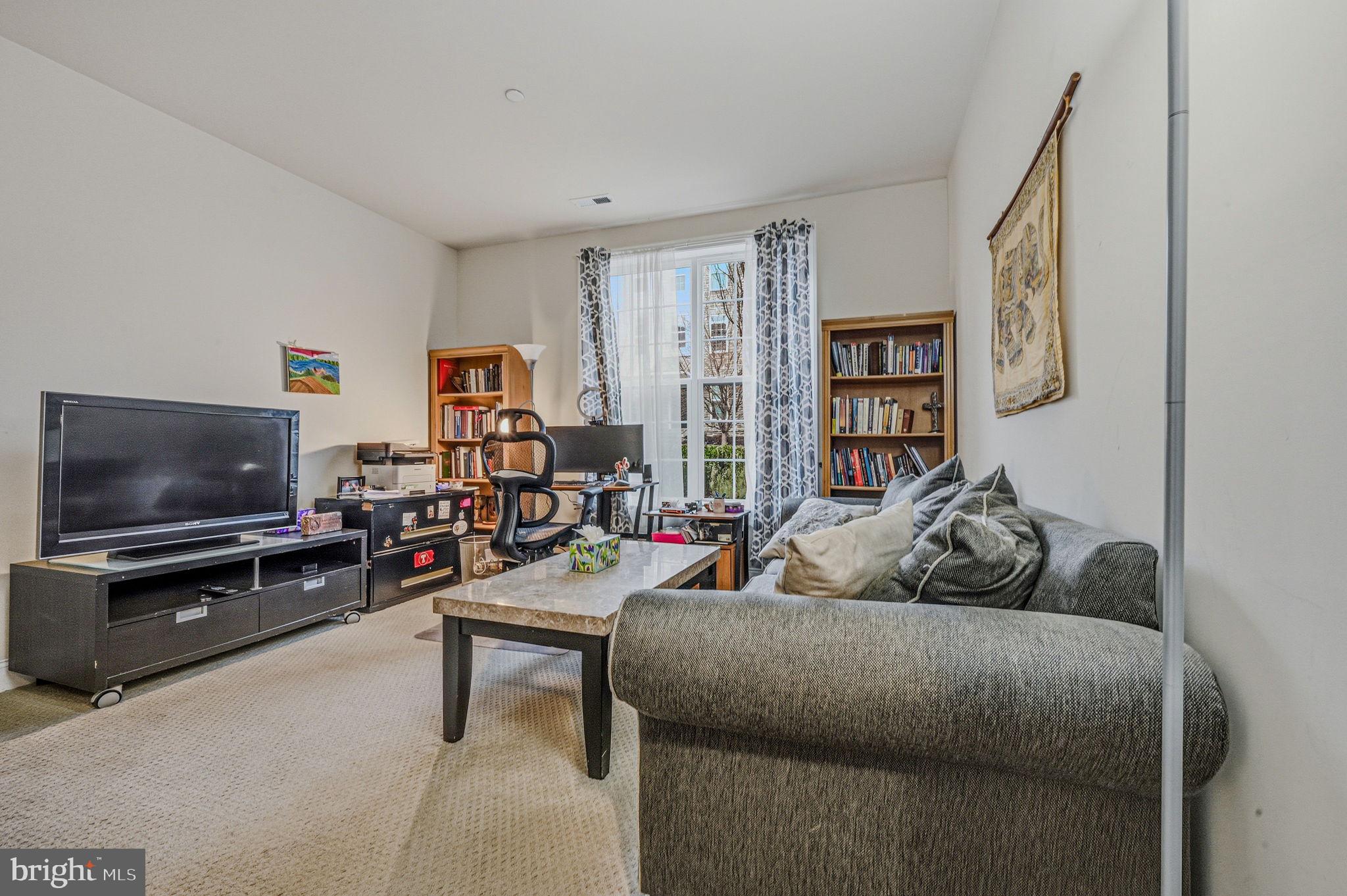208 Jackdaw Alley, Unit 208 Springfield, PA 19064 - Photo 7 of 43 a living room with furniture and a flat screen tv