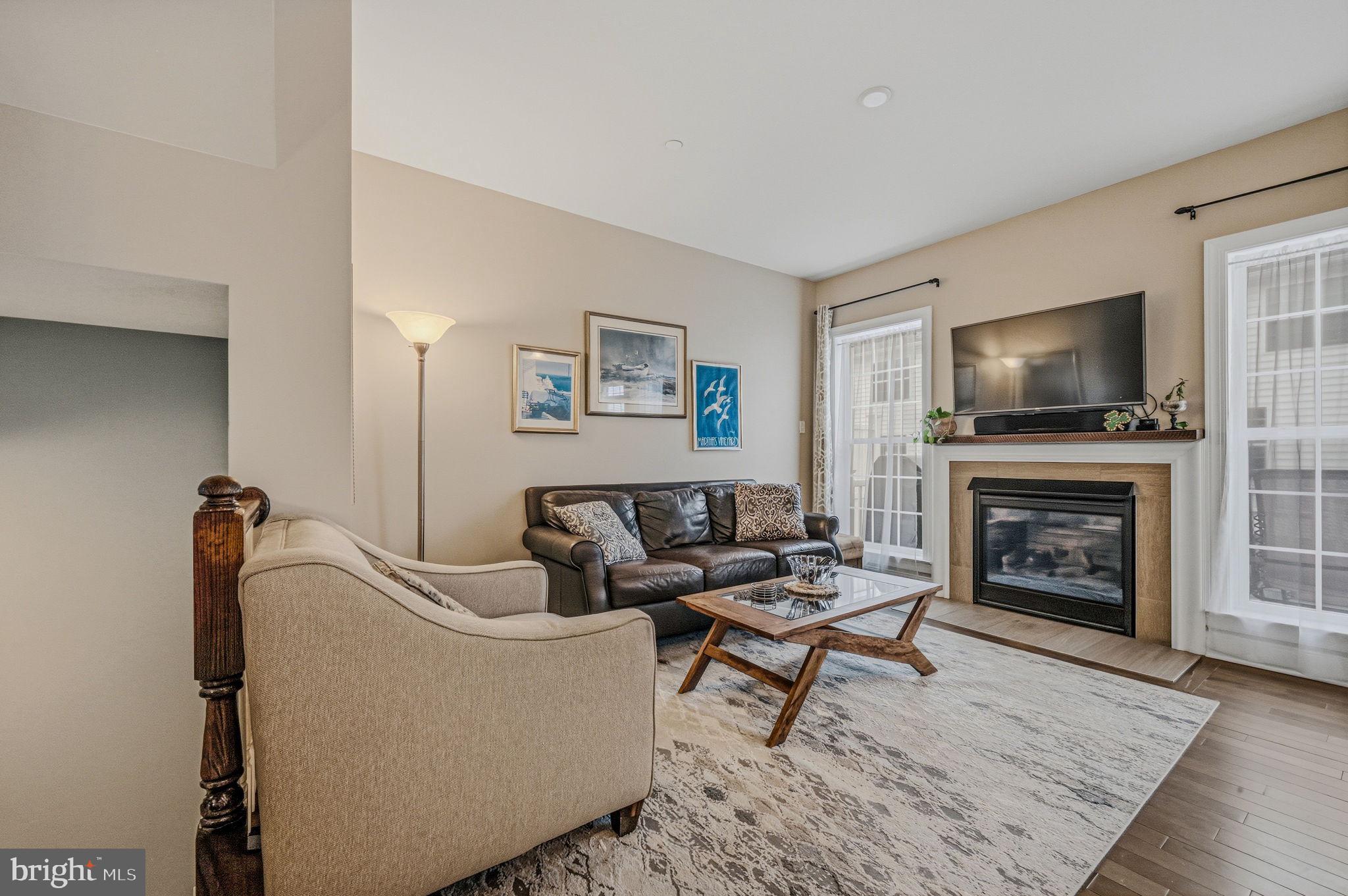 208 Jackdaw Alley, Unit 208 Springfield, PA 19064 - Photo 10 of 43 a living room with furniture a flat screen tv and a fireplace