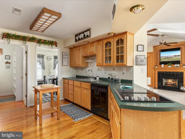 a kitchen with stainless steel appliances granite countertop a sink and cabinets