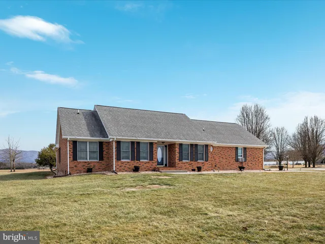 a view of a house with a yard and lake view