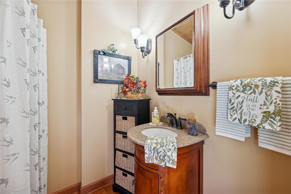4941 Bulltown Road Murrysville, PA 15668 - Photo 19 of 39 a bathroom with a granite countertop sink a mirror and a shower