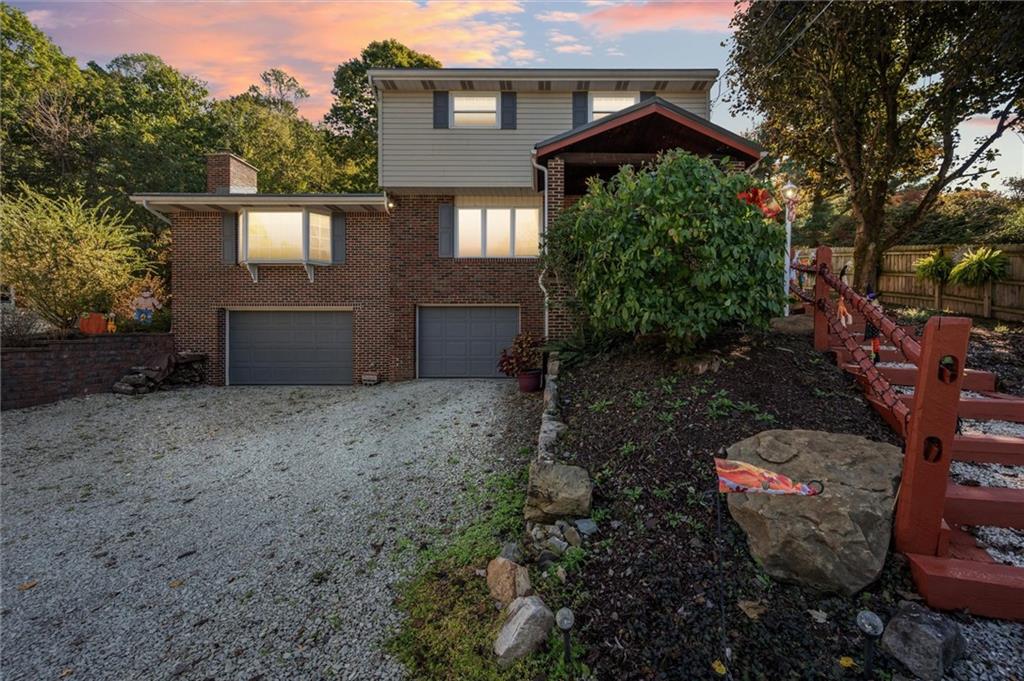 4941 Bulltown Road Murrysville, PA 15668 - Photo 2 of 39 a view of a house that has a small yard and large trees