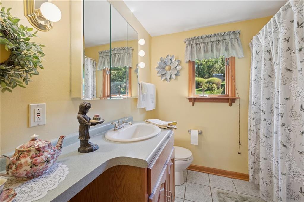 4941 Bulltown Road Murrysville, PA 15668 - Photo 25 of 39 a bathroom with a granite countertop sink a toilet and shower