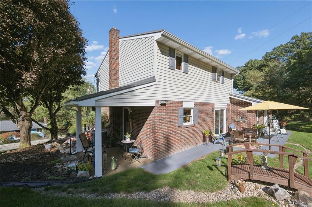 4941 Bulltown Road Murrysville, PA 15668 - Photo 38 of 39 a view of a white house next to a yard and chairs