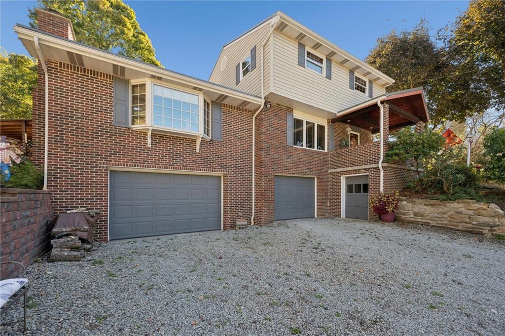 4941 Bulltown Road Murrysville, PA 15668 - Photo 4 of 39 a front view of a house with a yard and garage