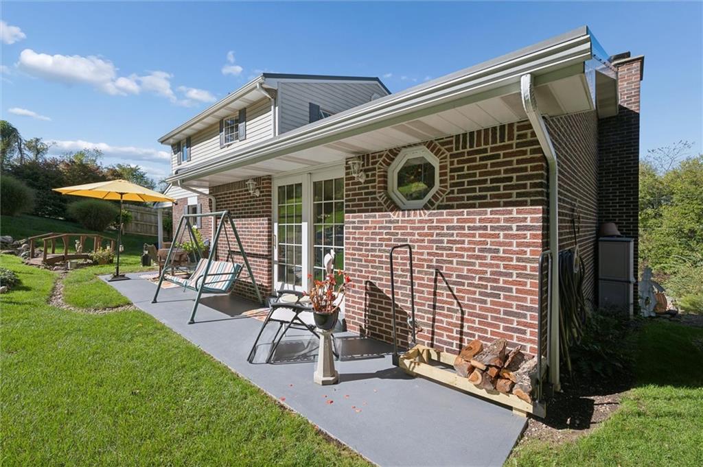 4941 Bulltown Road Murrysville, PA 15668 - Photo 5 of 39 a view of a patio with a table and chairs under an umbrella