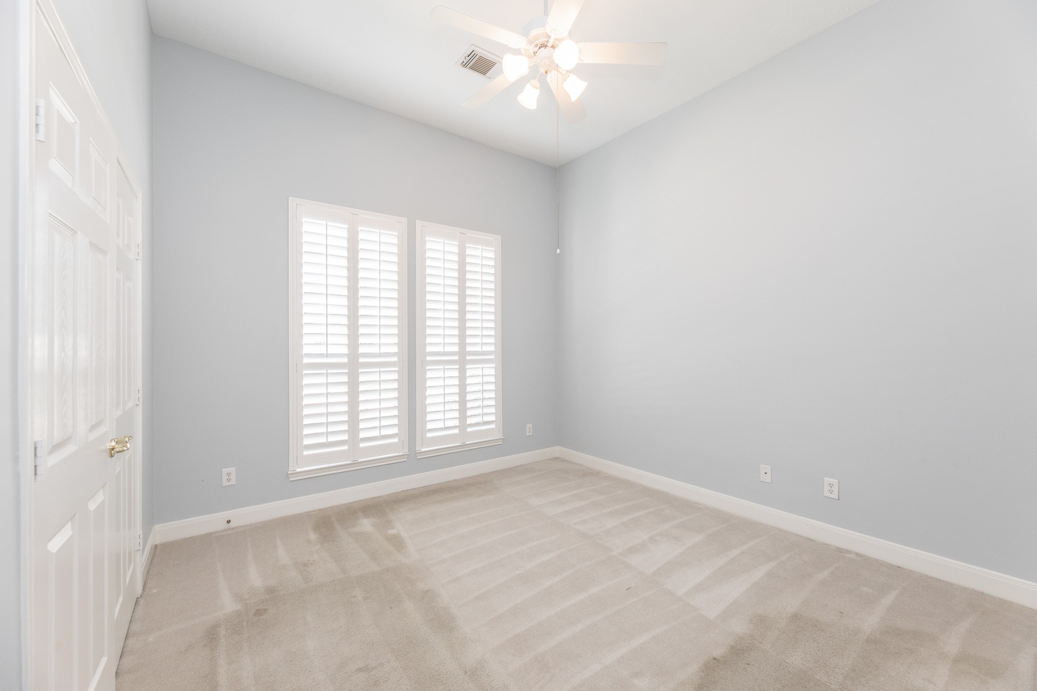 1222 Brinson Court Spring, TX 77379 - Photo 31 of 35 an empty room with chandelier fan and windows
