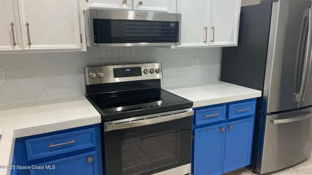 a stove top oven sitting inside of a kitchen