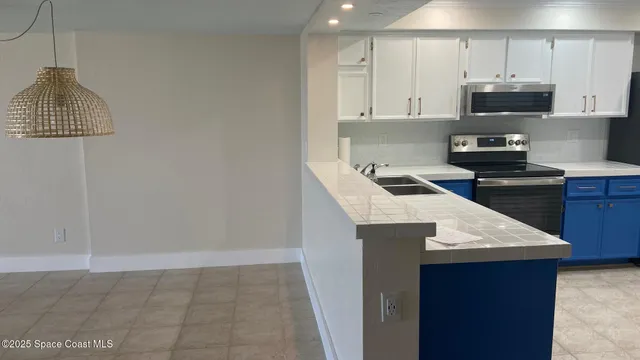 a kitchen with a sink a stove and cabinets