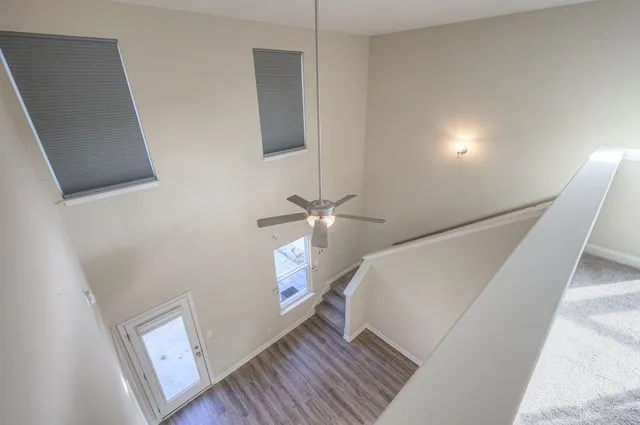 a view of a hallway with entryway wooden floor and front door