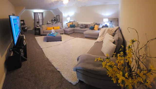 a view of living room with furniture and flat screen tv
