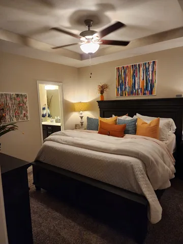 a bedroom with a bed and a chandelier