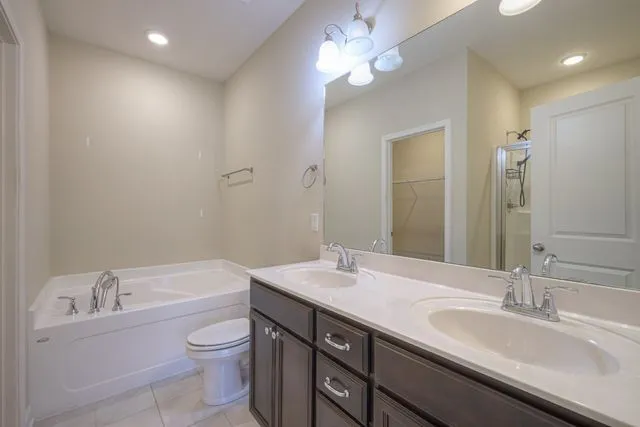 a bathroom with a granite countertop sink a toilet and a bathtub