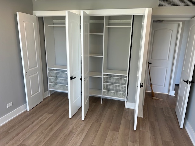 720 West Gordon Terrace, Unit 6D Chicago, IL 60613 - Photo 15 of 28 a view of walk in closet with wooden floor and entryway