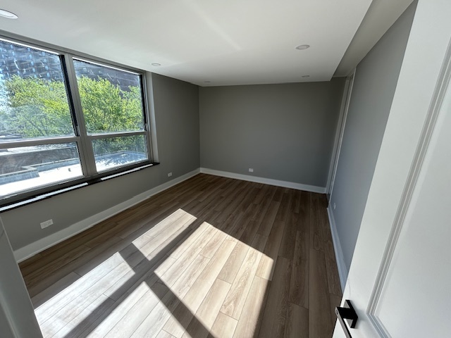 720 West Gordon Terrace, Unit 6D Chicago, IL 60613 - Photo 17 of 28 a view of wooden floor and windows in a room