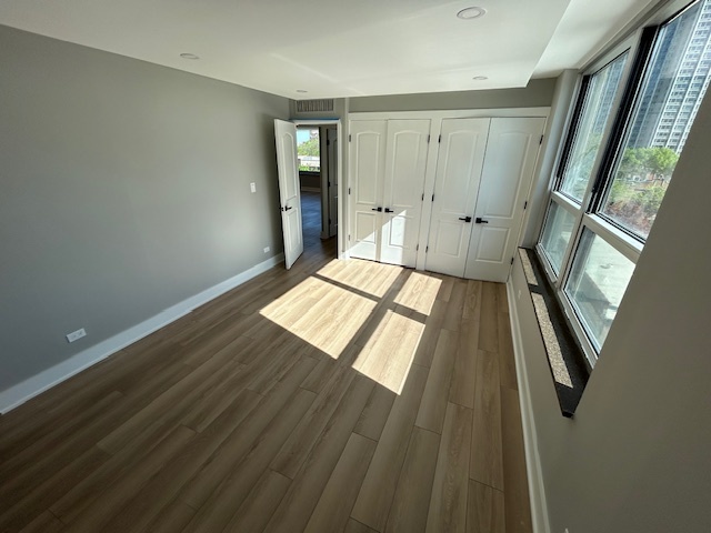 720 West Gordon Terrace, Unit 6D Chicago, IL 60613 - Photo 18 of 28 a view of an empty room with wooden floor and a window