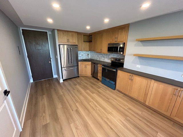 720 West Gordon Terrace, Unit 6D Chicago, IL 60613 - Photo 2 of 28 a kitchen with granite countertop stainless steel appliances refrigerator and microwave