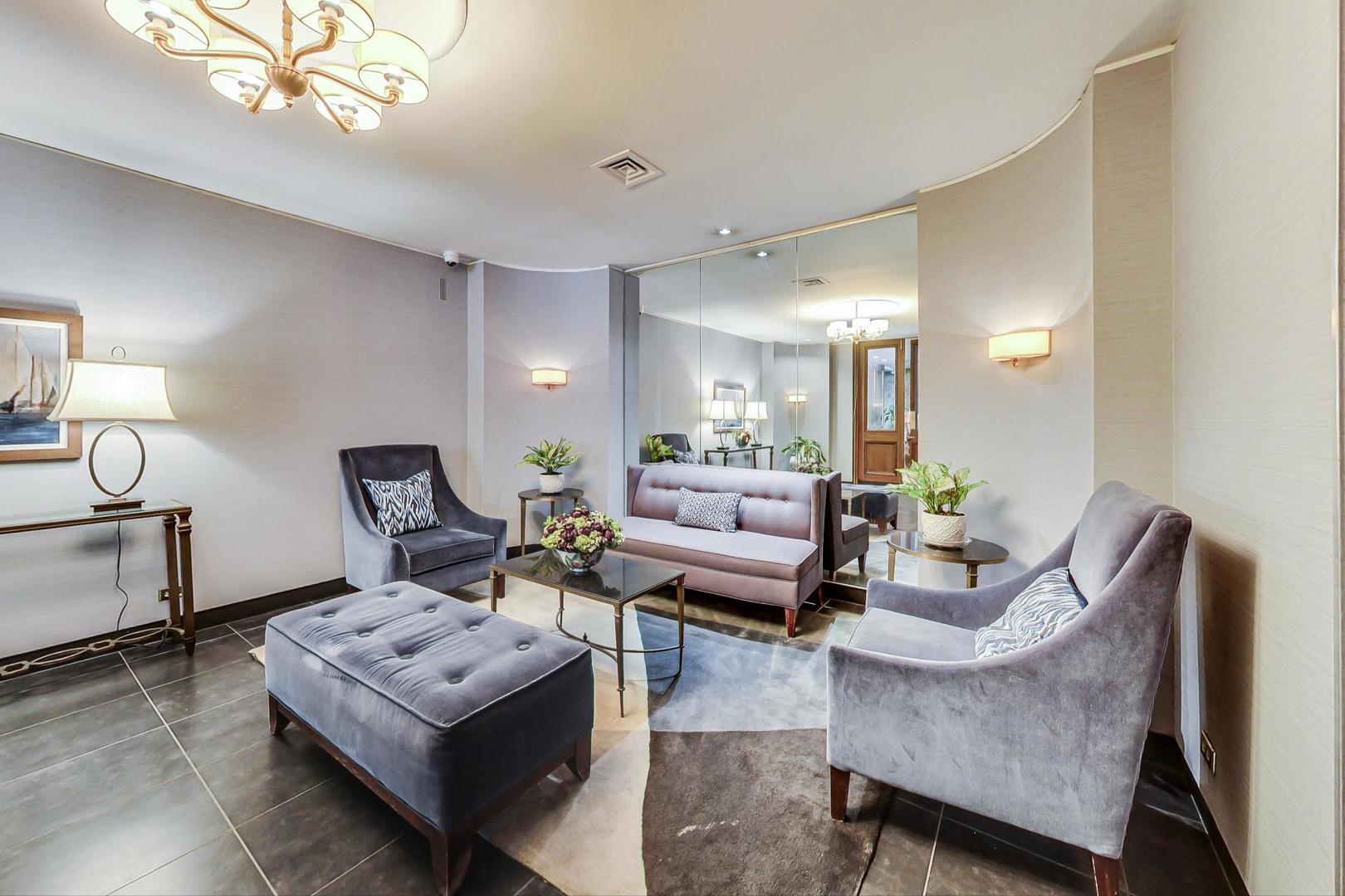 720 West Gordon Terrace, Unit 6D Chicago, IL 60613 - Photo 23 of 28 a living room with furniture and a chandelier