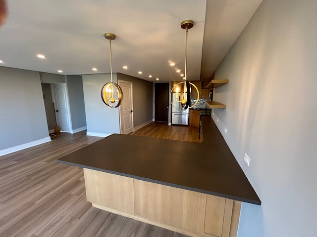 720 West Gordon Terrace, Unit 6D Chicago, IL 60613 - Photo 7 of 28 a view of a hallway with wooden floor