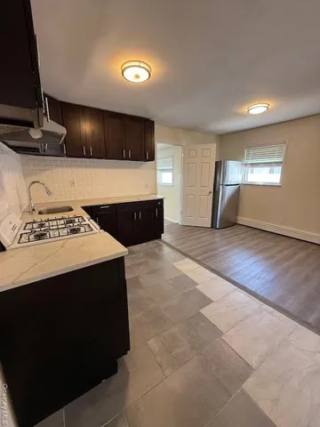 a view of kitchen with sink and cabinets