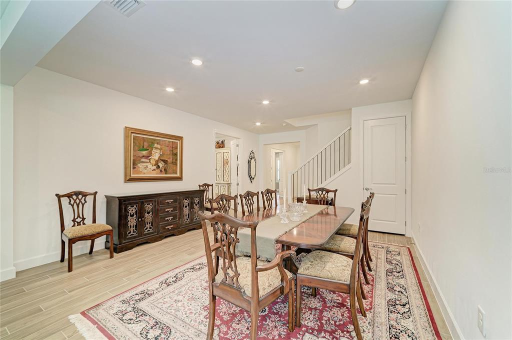 16341 Hidden Oak Loop Lakewood Ranch, FL 34211 - Photo 9 of 76 a view of a a dining room with furniture window and wooden floor