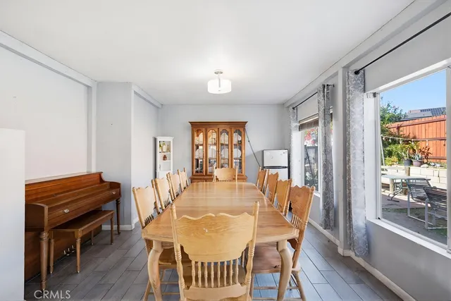 a dining room with furniture and wooden floor