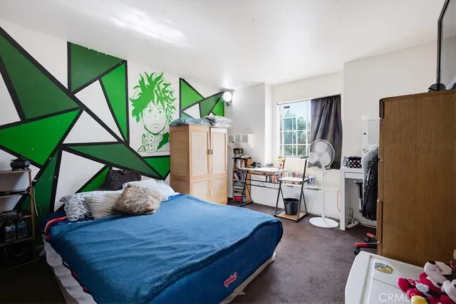 a bed room with a bed table and a window