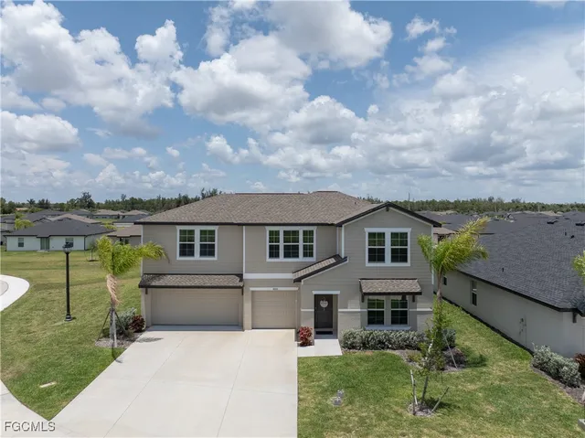 a front view of a house with a garden and yard