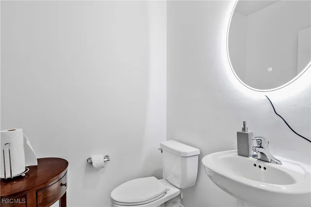 a bathroom with a sink a mirror and a toilet