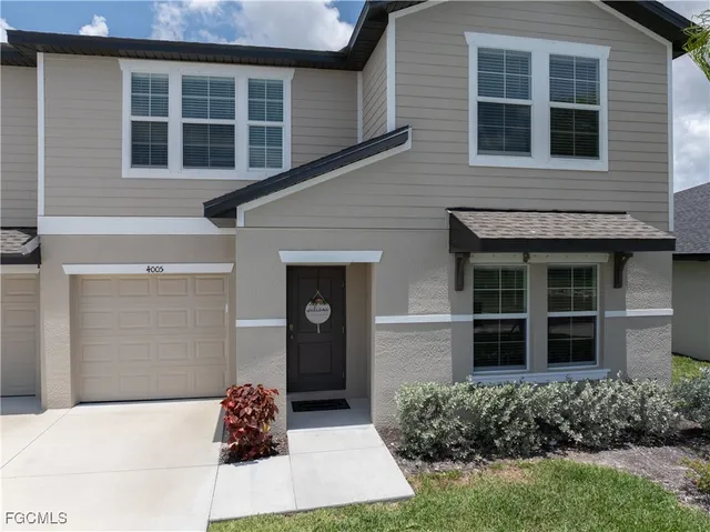 a house with potted plants in front of door