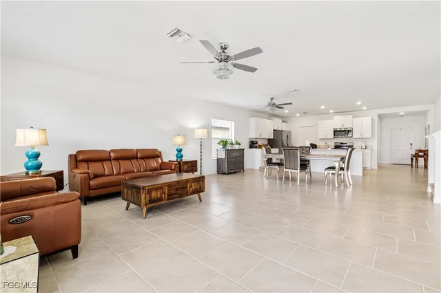 a living room with furniture and kitchen view