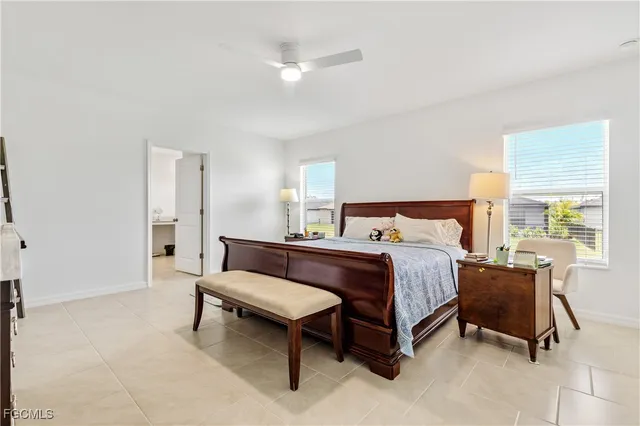 a spacious bedroom with a bed and a chandelier