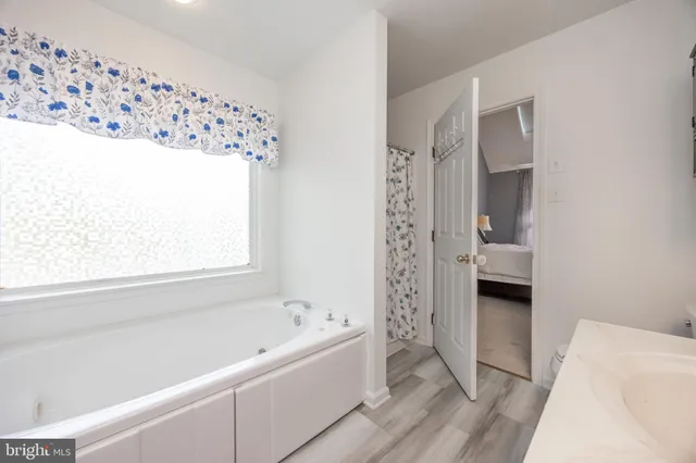 a bathroom with a bathtub and a shower