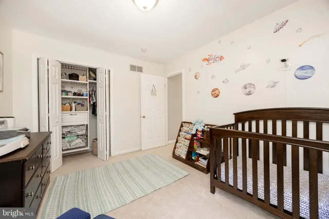 a bedroom with furniture and a wooden floor