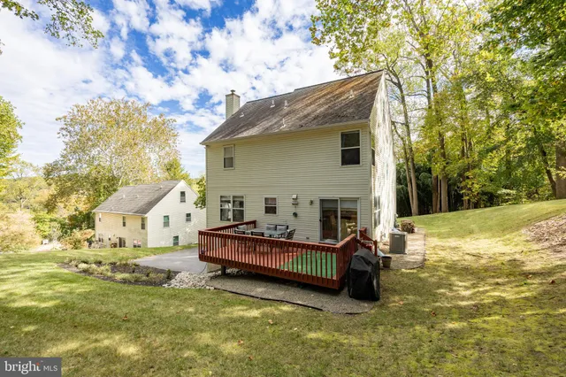 a view of house with yard and sitting area