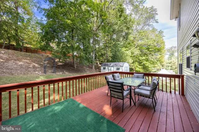 a view of a wooden deck with furniture