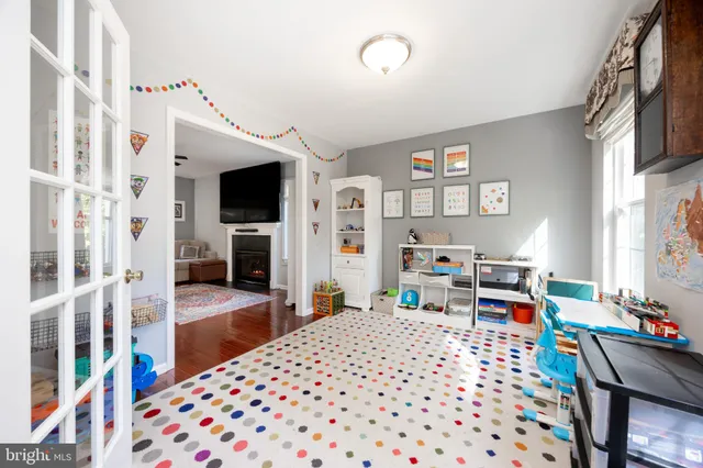 a bedroom with furniture and a wooden floor