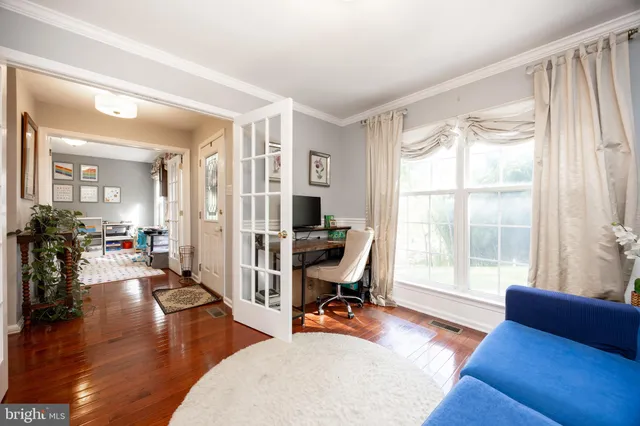 a view of a livingroom with workspace and a window