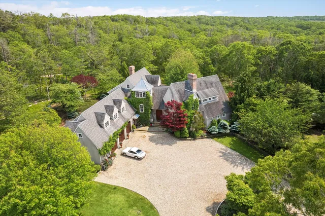 an aerial view of a house with a yard