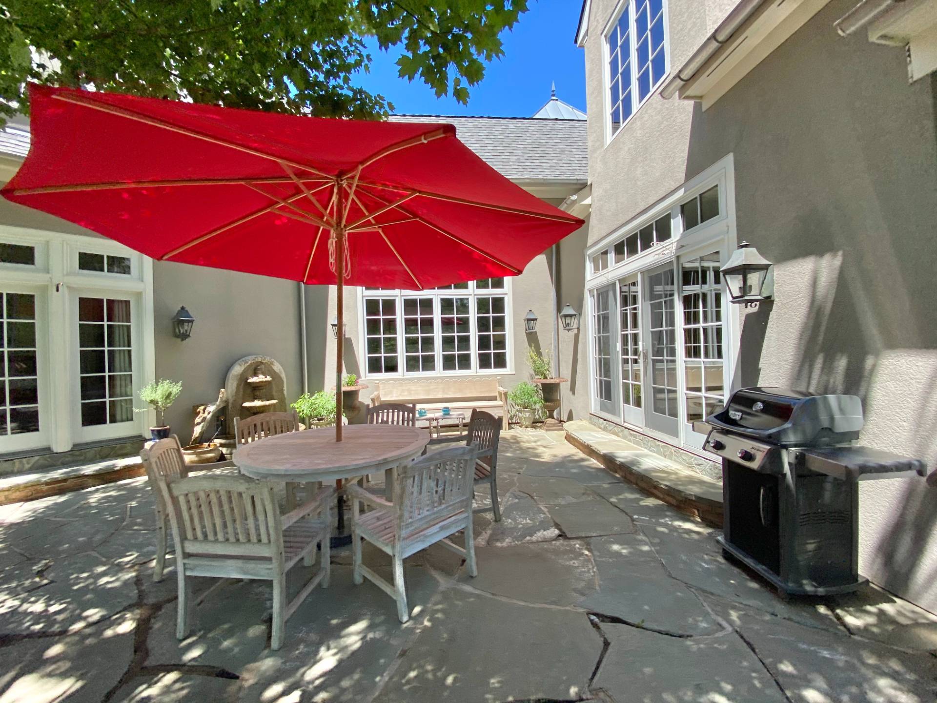 200 Great Hill Road Southampton, NY 11968 - Photo 6 of 44 a patio with glass top table and chairs