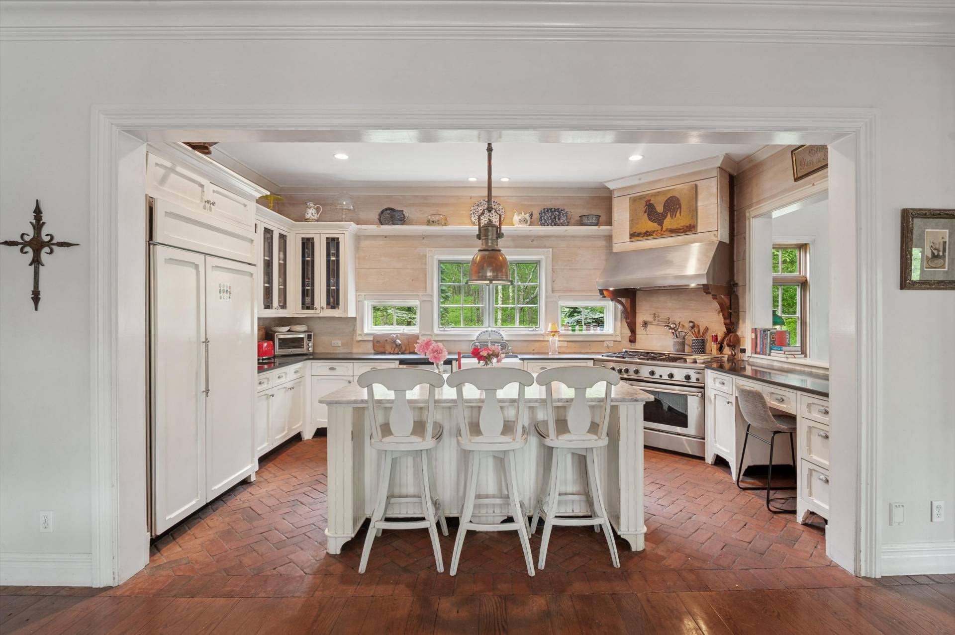 200 Great Hill Road Southampton, NY 11968 - Photo 9 of 44 a kitchen with stainless steel appliances kitchen island granite countertop a stove a refrigerator and a dining table with wooden floor