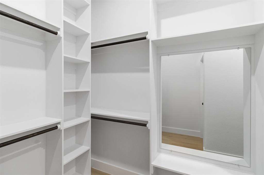 435 Waterboard Road Trinidad, TX 75163 - Photo 28 of 39 Custom closet system featuring white shelving, multiple hanging rods, and an integrated mirror