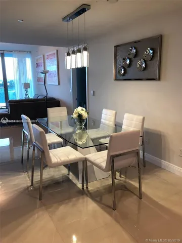 a view of a dining room with furniture and chandelier