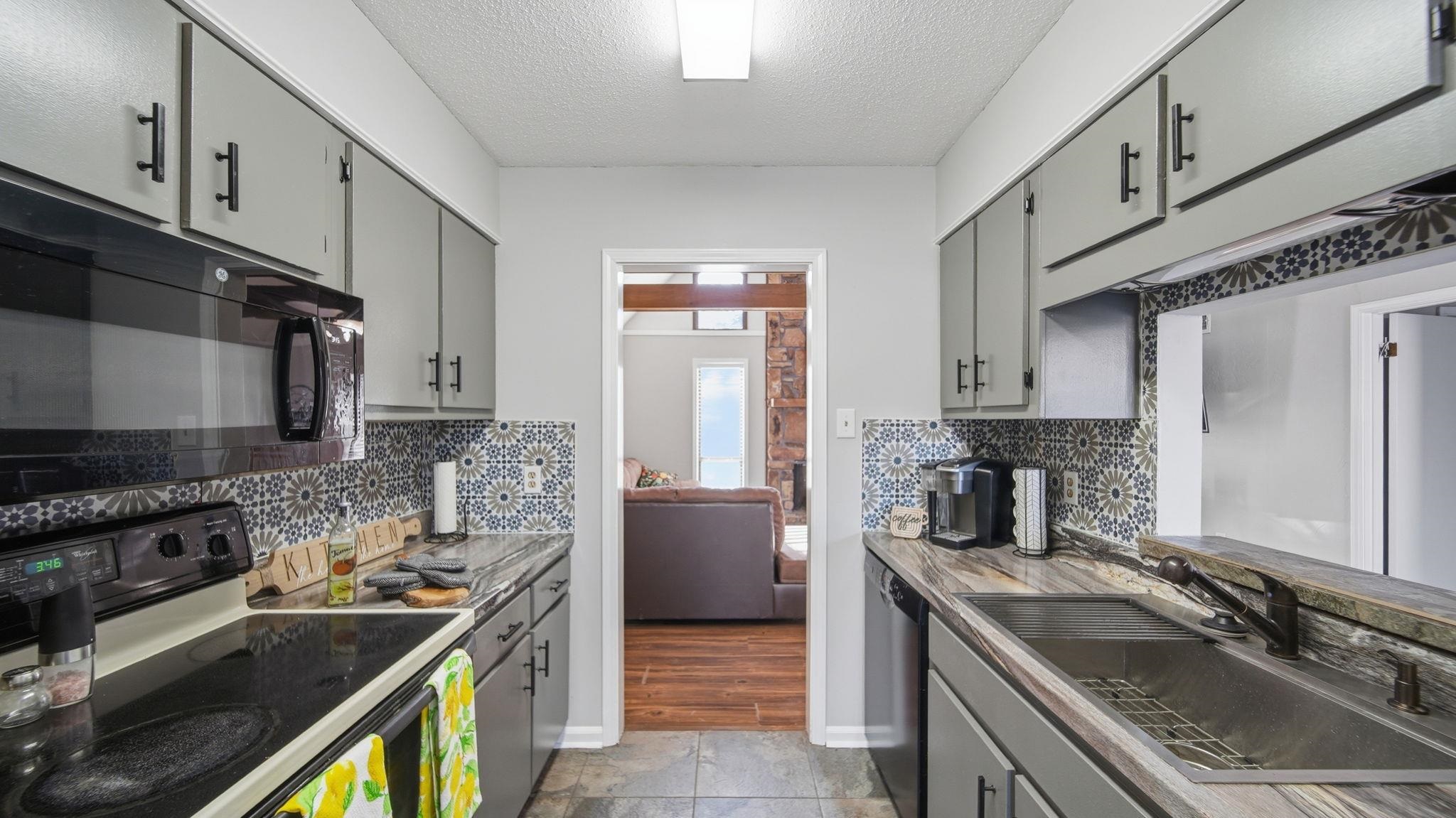 4182 Luther Road Bartlett, TN 38135 - Photo 25 of 40 a kitchen with stainless steel appliances granite countertop a sink stove and refrigerator
