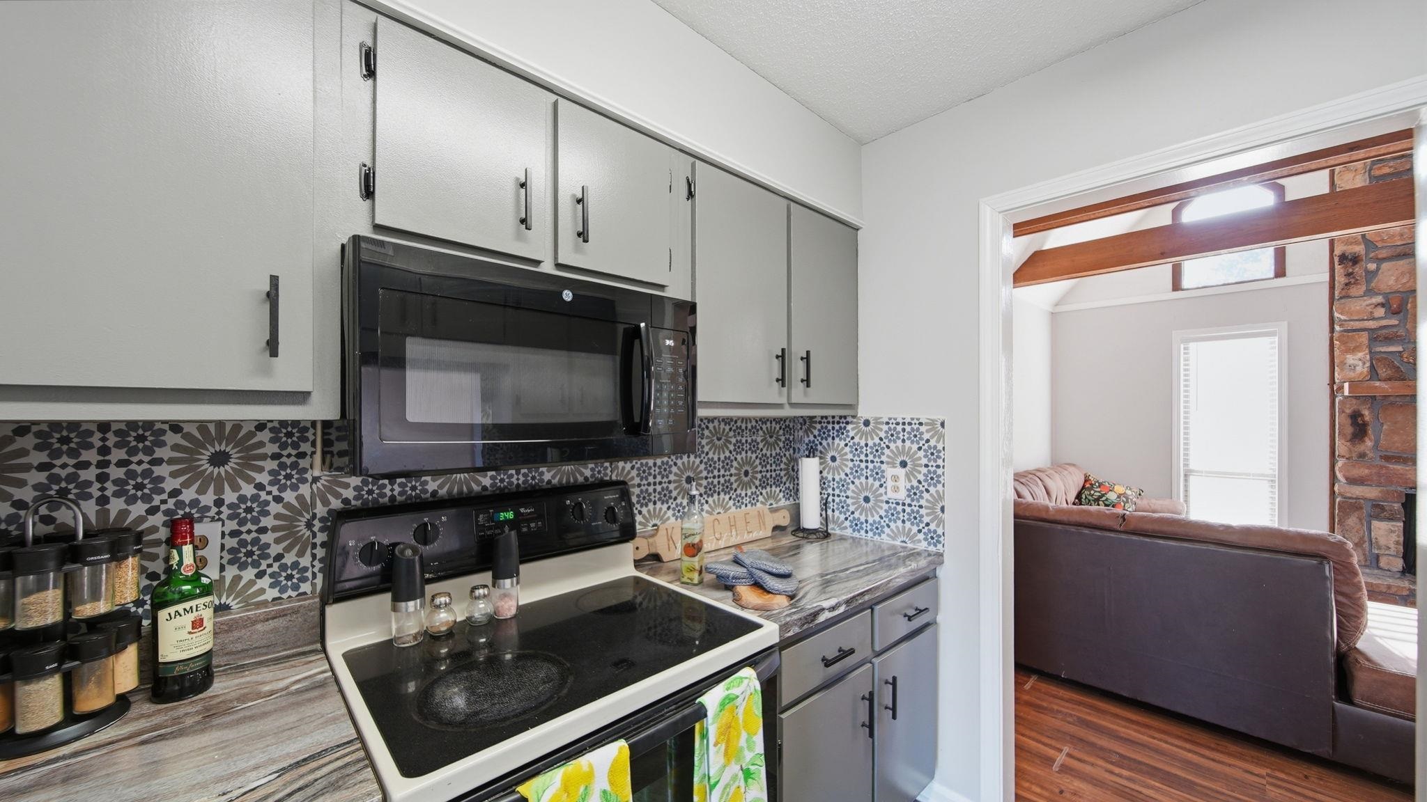 4182 Luther Road Bartlett, TN 38135 - Photo 26 of 40 a kitchen with stainless steel appliances granite countertop a stove a sink and a microwave